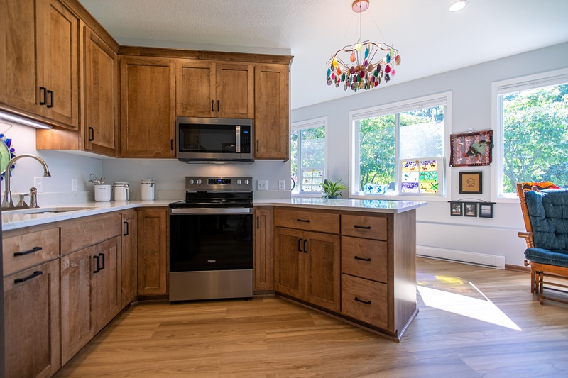 Custom kitchen with wood cabinetry and peninsula in Dayton, MN ADU addition