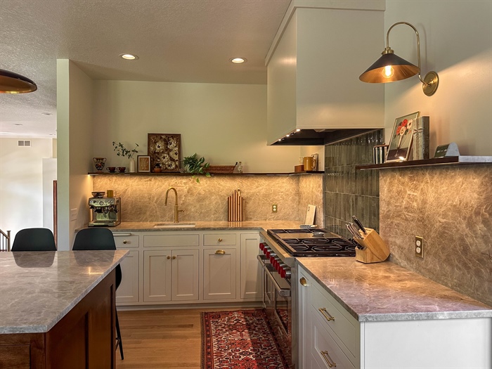 Custom Long Lake kitchen with quartzite surfaces, white cabinetry and professional range