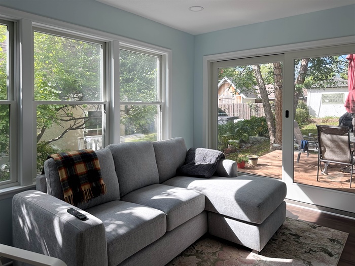 Bright living space with large windows and sliding doors to rear deck in South Minneapolis home addition
