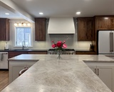 Custom T-shaped kitchen island with quartzite countertops in Hopkins, MN remodel